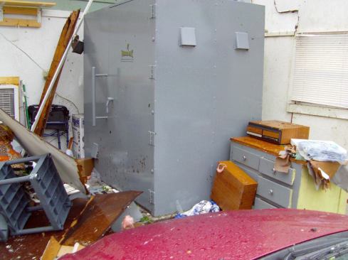 A Twister Safe tornado shelter sits amid debris in the aftermath of the tornado.