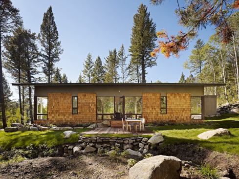 8-foot-tall windows on either side create a transparent living room at architect John Carney’s Fish Creek Guest house in Wilson, Wyo.
