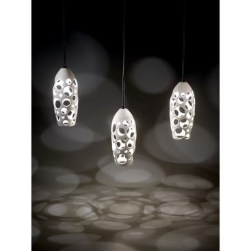 These Halo pendants are cast in porcelain and finished off with a glaze. Each piece has an open-web shade that allows light to filter out. Various colors are available. 
www.rossedwardsdesign.com.