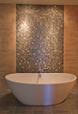 Ceramic tile disguised to look like stone gives the feel of a natural waterfall cascading down through the master bath. Project: Frank Bath; Architect/Designer/Contractor: Mabel Tweddle, Alexandria, Va.