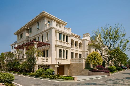 Grand, International Residential Project - Attached Under 1.0 FAR. Builder: Minhou Rongqiao Real Estate Co., Ltd. Architect: Dahlin Group Architecture Planning. Constructed with local materials by stone craftsmen, these classically styled villas, townhouses and duplexes are strategically placed around the natural waterways in Fuzhou, China.