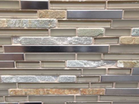 Another new product from Daltile is this linear blend of glass and natural stone pieces stacked in an asymmetrical pattern. www.daltile.com