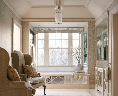 The deck-mounted tub is tucked into a niche so that the rectangle of the room gives a gracious, spacious feel. This, in turn, allows space for furniture. Mirrored panels allow daylight to travel through the room, adding an airy feel.
