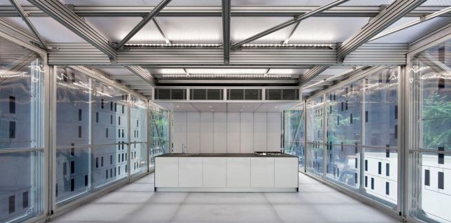 The SmartWrap wall assembly consists of four functioning layers—an outer transparent PET weather barrier, an inner PET layer with thin-film photovoltaic cells, an inner layer of solar heat and UV blocking film, and an interior layer of PET—set in an extruded aluminum frame. The walls were designed to produce active and passive thermal strategies.