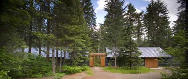 Designed for year-round enjoyment, Bohlin Cywinski Jackson's Sheldon Gatehouse is a modest one-bedroom home with guest suite, both in separate volumes oriented around an outdoor courtyard with a stainless steel fireplace. The garage can be adapted to a studio/workspace.