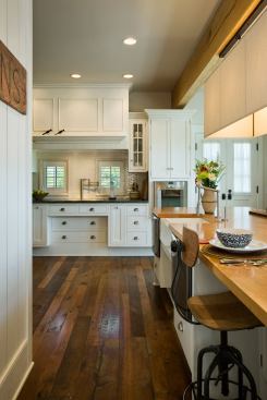 Both the apron-front sink and the cooktop have recessed cabinets beneath to allow close access from a chair without losing valuable storage.
