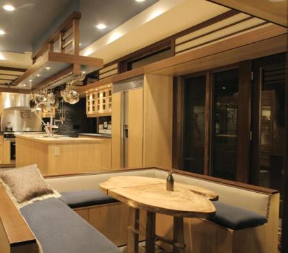 The corner kitchen opens on its narrow end to a cozy dining nook. The wider side presents a public face to the larger living spaces.