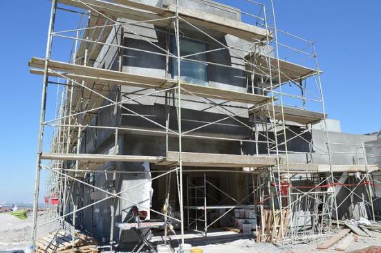 Scaffolding helps workers reach all levels of the exterior.