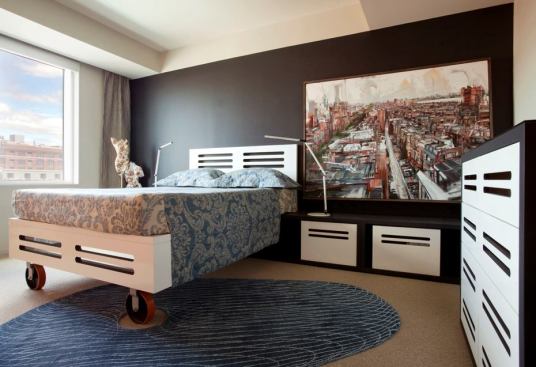 The bedroom has a bed on wheels that can be rolled out of the way for yoga practice.