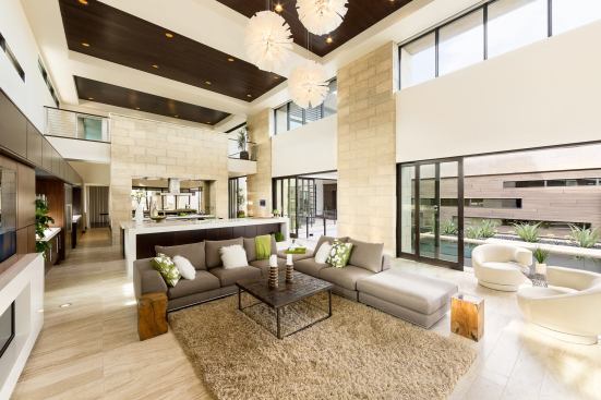 The great room opens to both the kitchen and outdoor space.