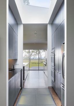 The pantry’s glass floor panels transmit light to the house’s lower level.
