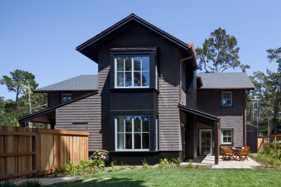 The double-height window bays helped mitigate the scale of the duplex. “The single bay allows the structure to read as one large house,” Christensen clarifies, “but it also articulates the middle of the duplex and breaks up the wall.”