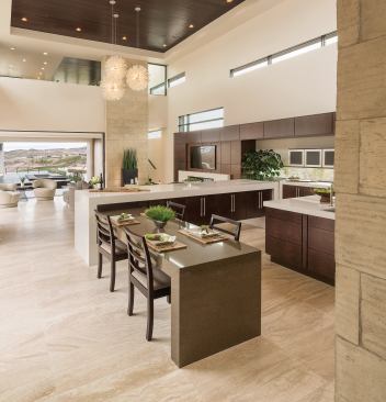 The kitchen combines comfort, convenience, and coolness with a high-contrast cabinet-countertop combo set off by a stainless steel appliance and fixture package. There’s more than enough storage and surface area, especially considering a perimeter run that stretches into a butler’s pantry.