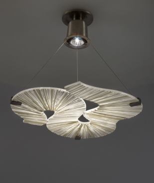 The Skli (Norwegian for “slide”) lighting fixture is named for its suspended screen, which Finne formed by hand from glass rods.