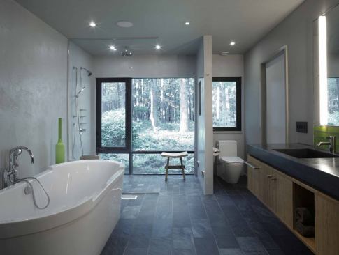 Materials in the master bath include slate flooring, an integral concrete sink and counter on a bamboo base, and troweled concrete plaster walls.