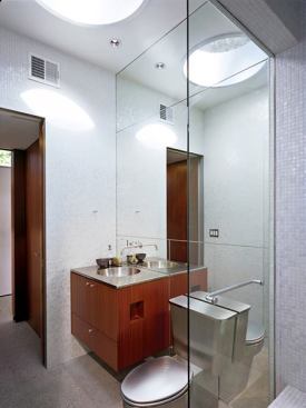 The sleek interior bath is accessible from the interior and from the exterior, through the shower which serves both inside and outside.