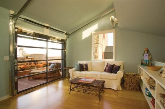 The loft’s rooftop sunroom opens onto a private deck via a glazed overhead door.   residential architect, November/December 2011  New Heights  Loft Residence, Minneapolis  Albertsson Hansen Architecture, Minneapolis