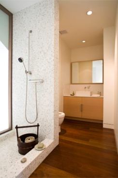 The bathrooms in the main house are clad in white mosaic tile.