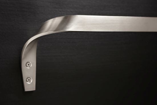 Designing seemingly incidental hardware, like this custom stainless steel towel bar, gives Finne a fine-grained control of his projects.