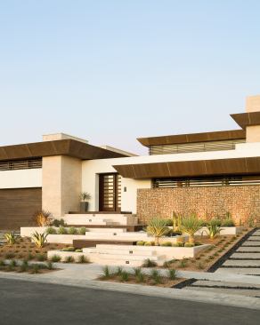 Compared with what lies beyond it, the home’s front elevation is understated yet welcoming, featuring the lines and massing of distinct yet complementary materials that continue inside. The elevated entry not only reflects the long, narrow lot on which the home is built, but also helps enable the full-height, below-grade spaces that further distinguish the project.