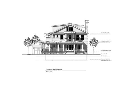 At the home's north elevation is a garage, set back and required by zoning ordinance. Behind it is the outdoor shower.