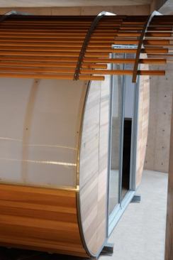 Polycarbonate glazing permits light while maintaining privacy, and cedar cladding adds a touch of elegance.