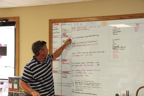 Tom Mayberry with his job scheduling board at his Joplin office. Before the tornado struck, Mayberry and his company team were already adept and scheduling and managing dozens of concurrent insurance repair jobs.