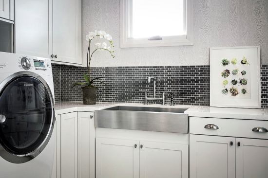 A full-size laundry room is located adjacent to the second-floor master bedroom. The house is also outfitted with a stackable unit in a closet near the pool for wet towels.