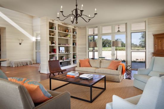 Two mirror-image volumes--a living room at the north and a kitchen-dining great room at the south--flank the central hall.