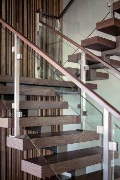 Glass railings reinforce the staircase's weightless look.