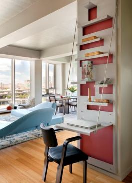 An aluminum wall-hung desk folds up and a similar shelf suspended inside a window bay holds an electric piano.