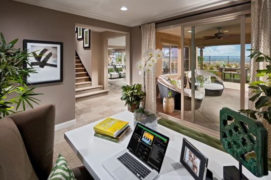 Flexible rooms often replace formal living rooms. The view from this flex space turned home office at Estates at Morgan Hill in Temecula, Calif., connects to the great room and outdoor living area.