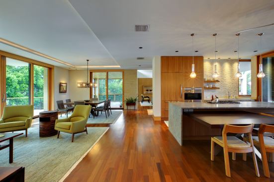 Details such as varied ceiling heights, wood cladding, and freestanding elements make the open rooms of this modern home--including its dining area--feel more defined. 
Project:
Osprey House, Osprey, Fla.; 
Architect: Sweet Sparkman Architects, Sarasota, Fla.; 
Builder: Michael K. Walker & Associates, Sarasota.