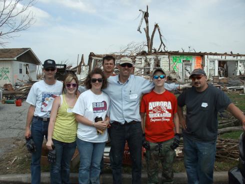 Volunteers pose for a photo near the destroyed home of Meri and Scotty Stewart, days after the tornado. Thousands of volunteers flocked to Joplin to help with cleanup.