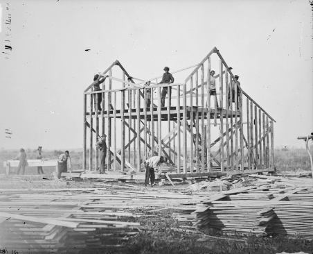 Balloon Framing. Ten men building a wood frame house, Omaha Reservation, Nebraska, 1877