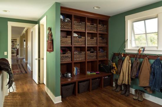 Floor-to-ceiling storage cubbies crafted in dark wood make this mudroom both handsome and helpful, with plenty of space to stow the trappings of everyday life as well as a spot to sit. Project: Wisconsin Farmhouse, Boyceville, Wis.; Architect: Rehkamp Larson Architects, Minneapolis; Builder: Red Cedar Construction, Menomonie, Wis.