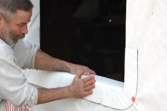 Finally, I smooth the vertical portion of the flashing against the housewrap.