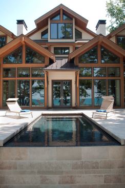 This house, situated on the shoreline of Lake Michigan, has an indoor pool with a soaring, two-story vaulted ceiling and an outdoor pool that feels like a continuation of the lake. Project: Carlton Shores, Lakeside, Mich.; Builder: Mike Schaap Builders, Holland, Mich.; Architect: Visbeen Associates, Grand Rapids, Mich.