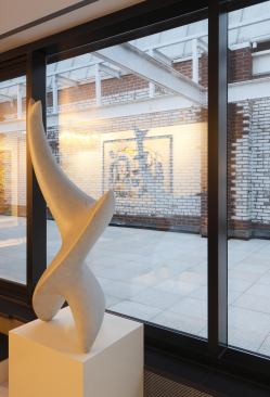 The parapet wall provides a gritty urban backdrop for a polished residence.