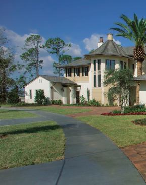 LONG SHOT: Highlighted by a two-story turret that encompasses a grand staircase at the main entrance, the front elevation mixes a variety of elements and detail to keep the eye interested across its considerable breadth.