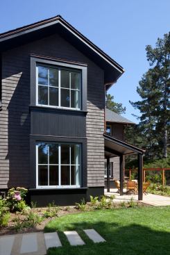 Architects Mary Griffin and Jerome Christensen speced dark shingles for the exterior to belnd into the trees and shadows of the wooded site.