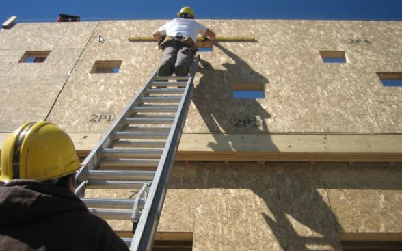 Small custom windows provide dappled light yet maintain privacy in the street-facing bedroom.