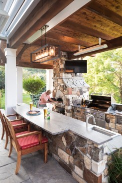 Outdoor Escape: Built for a transplanted California chef in Maple Plain, Minn., this covered outdoor kitchen by Mom's Design Build boasts several serious kitchen features, including a wood-fired pizza oven, grill, side burners, sink, fridge, and taps for beer and root beer.