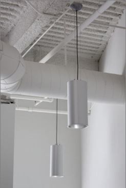 Cylinders (8000 Series) is a line of extruded aluminum lighting with a powder coat finish. The piece shown here measures 14 inches long by 4 inches wide and comes in brushed metal, bronze, black, and white. 
www.delraylighting.com.