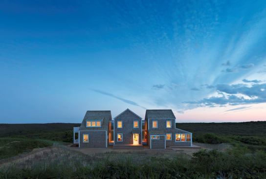 To maintain traditional proportions, this summer residence is split into three cottagelike pavilions.