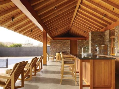 Taking its cue from Hawaiian pavilions and gardens, this kitchen uses exposed stone, beams, and a breezeway to stay connected to the surrounding gardens. Ample counter space doubles as a buffet area or bar. 
Project: Assembly House, Kona, Hawaii; Architect: Zak Architecture, San Francisco; Builder: Metzler Contracting, Hawi Hawaii
