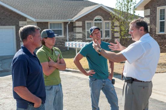 Left to right: Tom Mayberry, Jason Mayberry, Jake Mayberry, and Todd Decker at a rebuilt neighborhood in Joplin. A family business specializing in insurance work, the Mayberrys’ company has repaired hundreds of damaged homes in the year since the tornado, and built a number of complete replacement houses. They originally built the rental house in which Todd Decker rode out the storm.