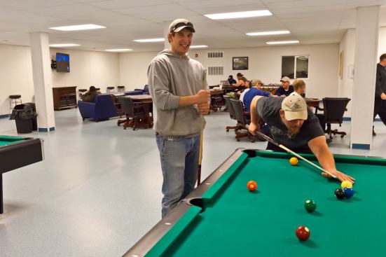 Oil-field workers Brant Jensen and Jonathan Lahm play pool in Target's Bear Paw lodge in Williston, N.D.