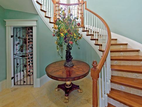 SMART STORAGE: The underside of the curving grand staircase serves as the perfect location for an in-home wine cellar which is insulated from the outside and from the bulk of activity inside by the tower's masonry construction.