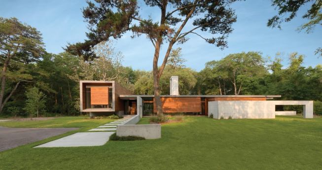 The Brays Island house sits in a clearing, surrounded by lush vegetation.